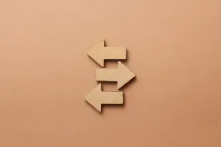 Three arrows on a brown background, each pointing in distinct directions, illustrating the concept of a two-way conversation.