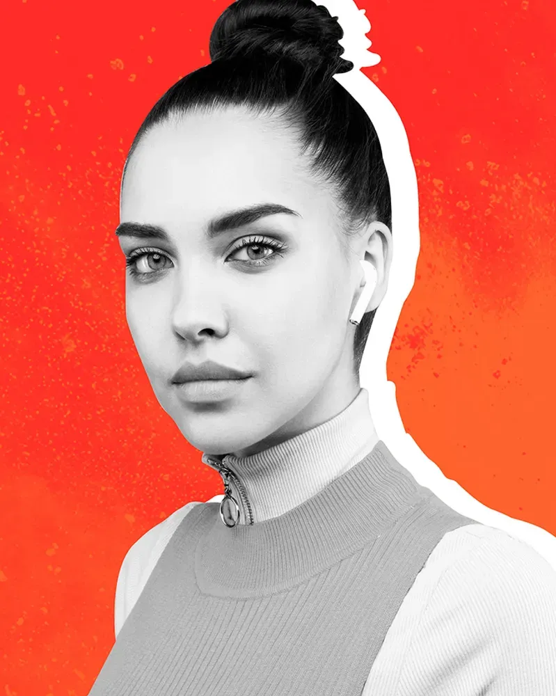 Woman standing against orange background