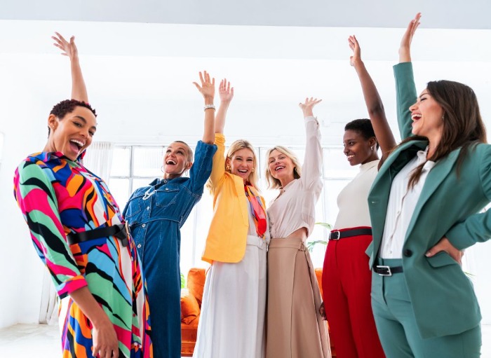female office workers celebrating with hands up