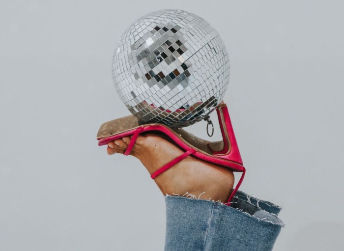 red high heels holding up disco ball
