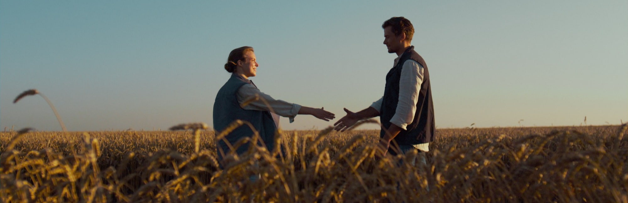 People Farmers shaking hands in a field 