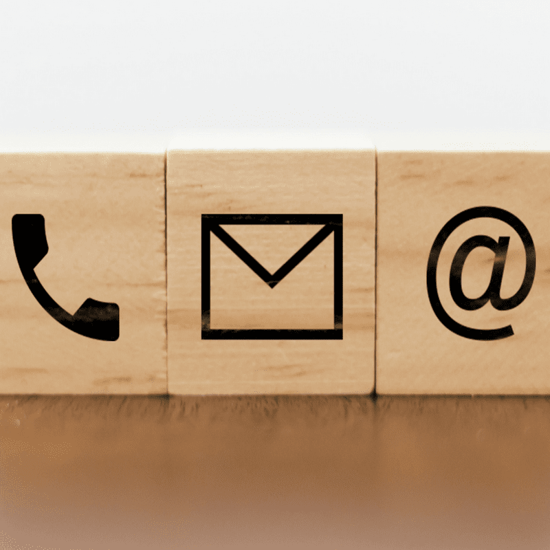 wooden blocks with telephone, email and social media symbols