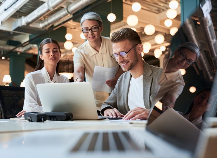 2 women and 1 man collaborating in office