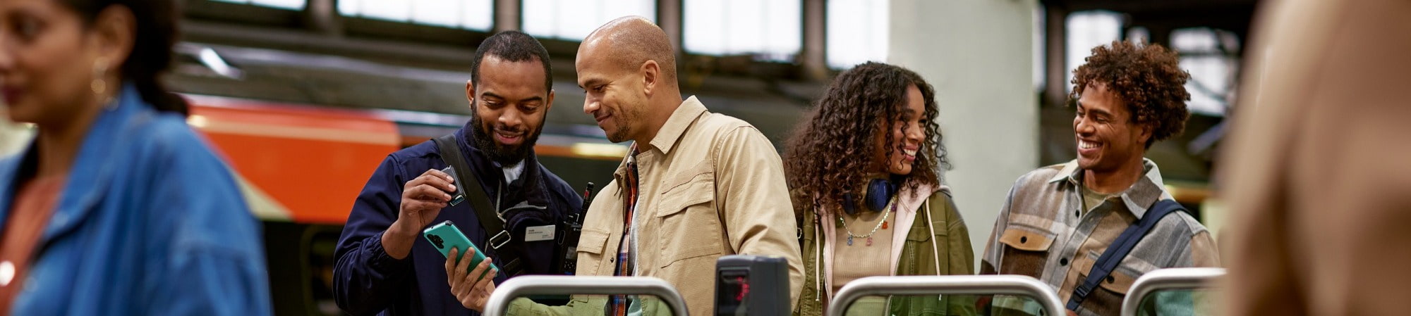 Avanti Colleague assisting passengers at the ticket barrier.