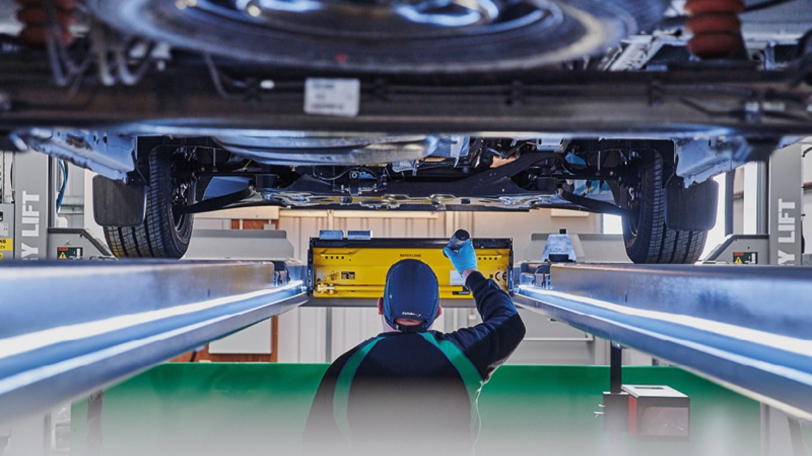 ATS Euromaster Team Member Inspects Vehicle 