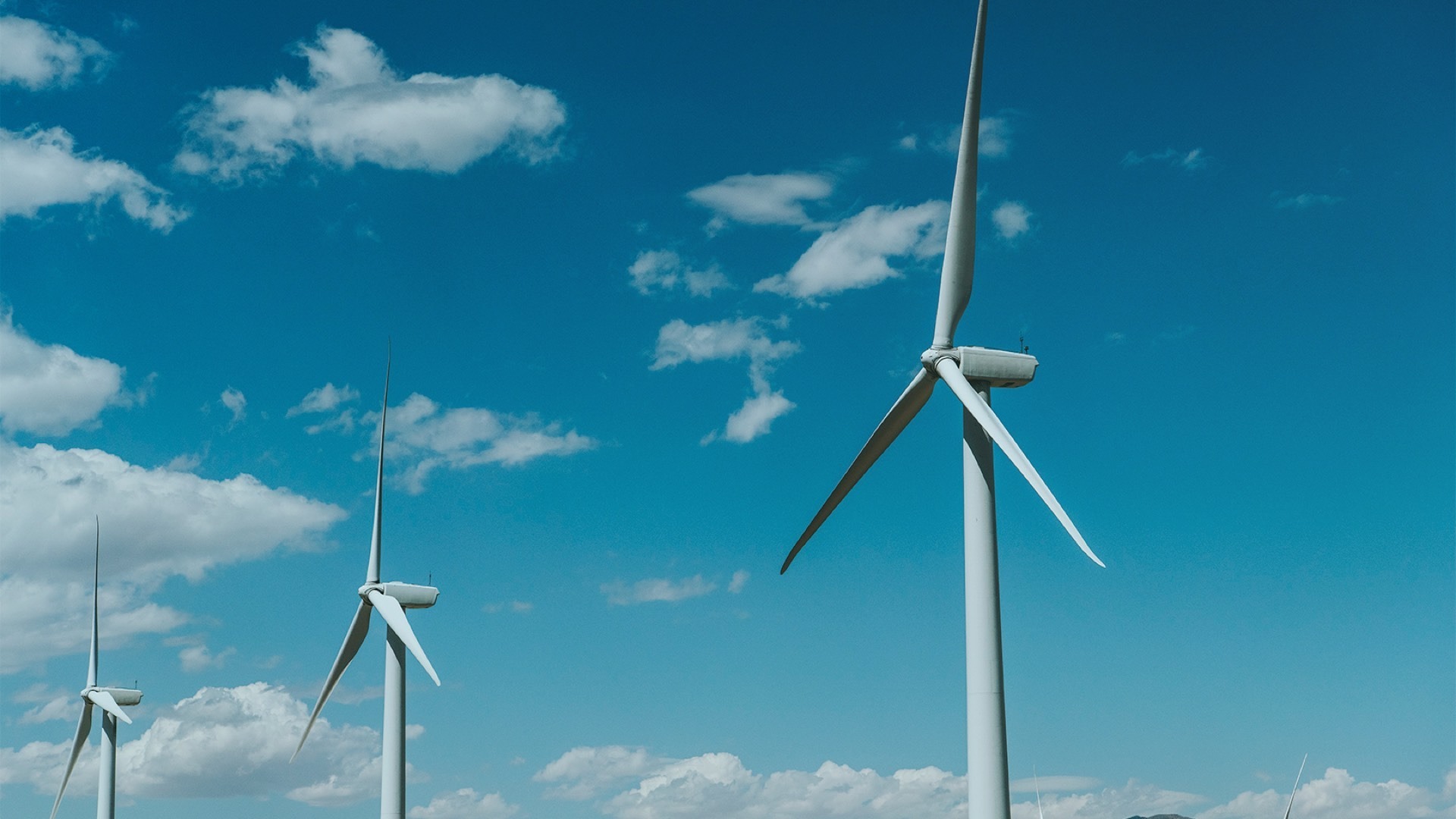 Wind turbines with blue sky and clouds