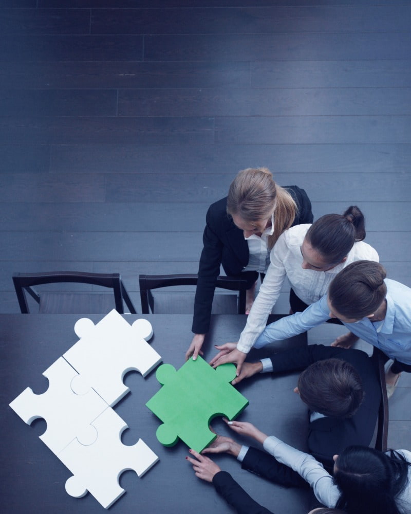 colleagues looking at a puzzle