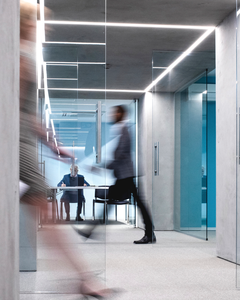 man and women walking through busy office