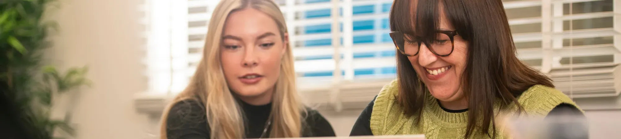 India Bradbury and Ashley Wilson in the Castle boardroom with laptop