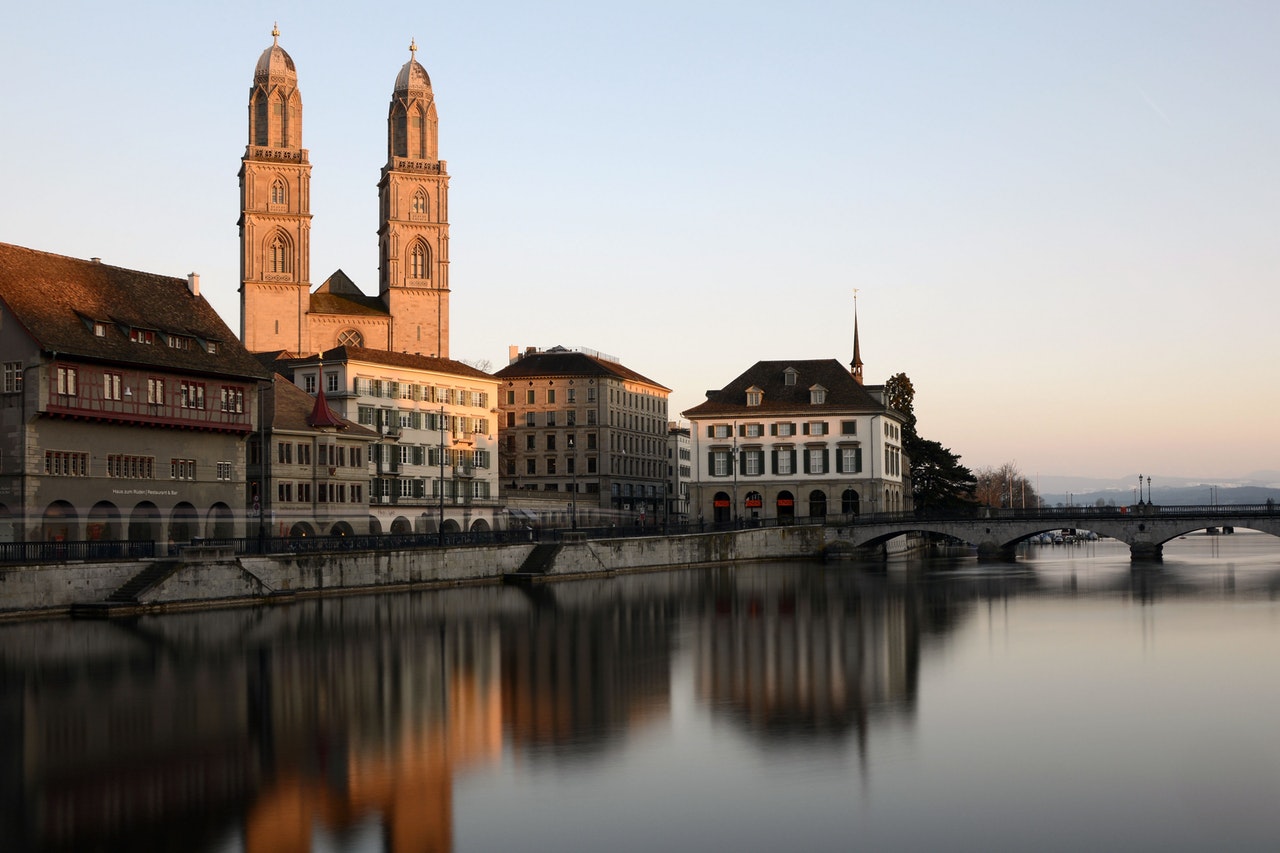Cathedral Behind Building Beside Body Of Water With Stone 161138