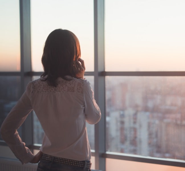 Woman on the phone looking out across a city skyline