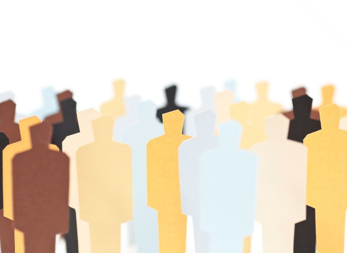 multiple paper cutout figures in different colours representing diversity