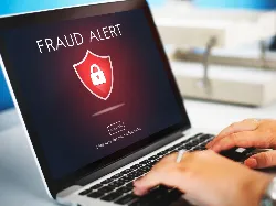 Fraud alert on laptop screen
