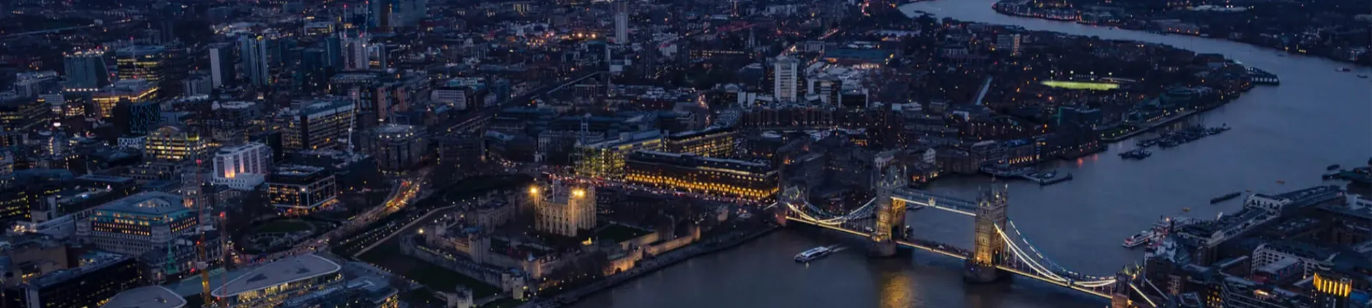 Ariel view of London at night with Tower Bridge and River Thames