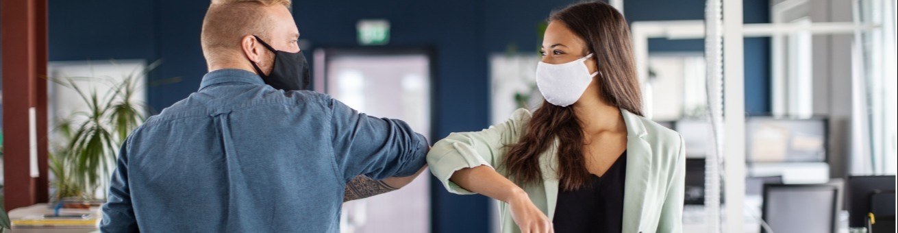 people in masks shaking hands