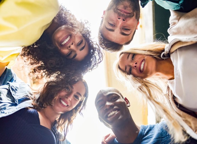 group of young people standing in a circle