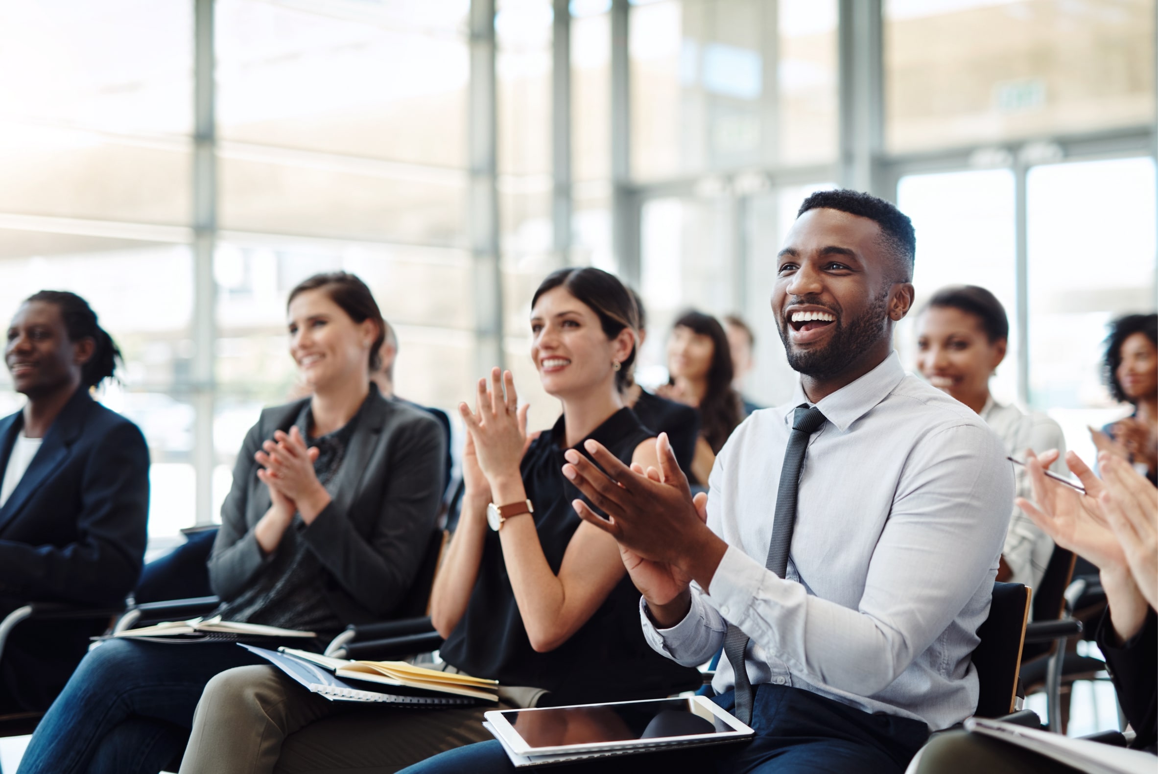 A group of seated people applauding