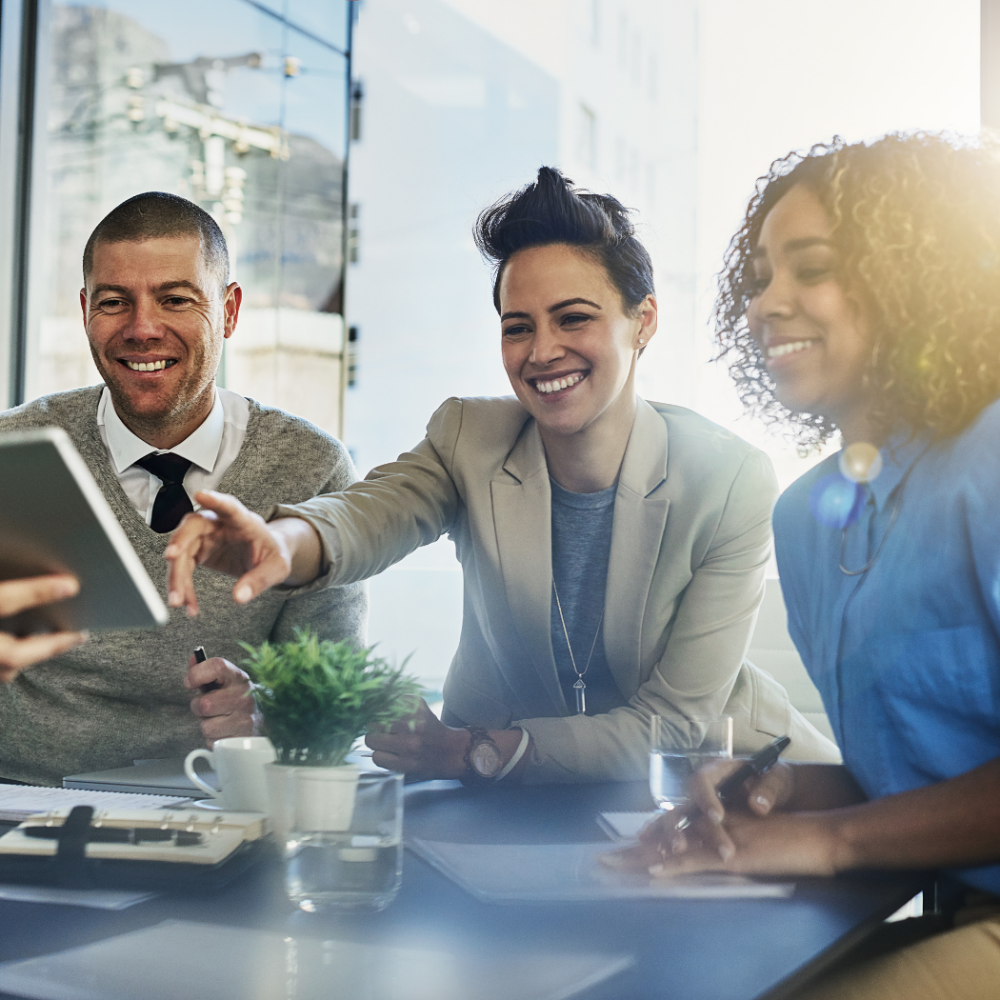 Business woman pointing at ipad during a meeting