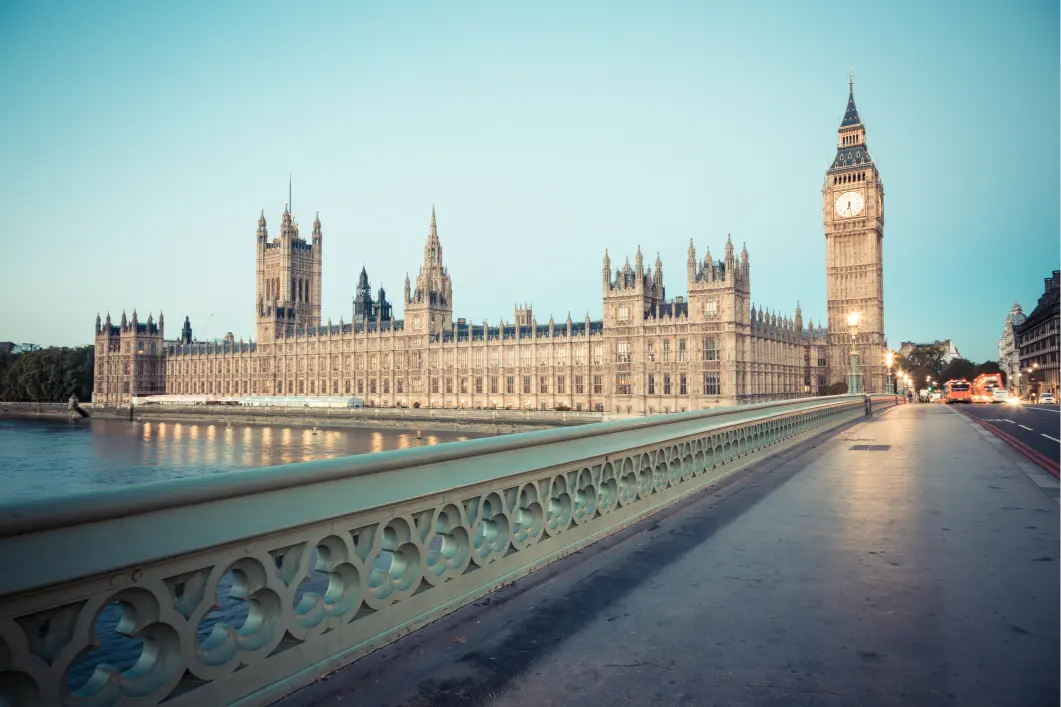 View of the London Houses of Parliament from the bridge with a blue sky