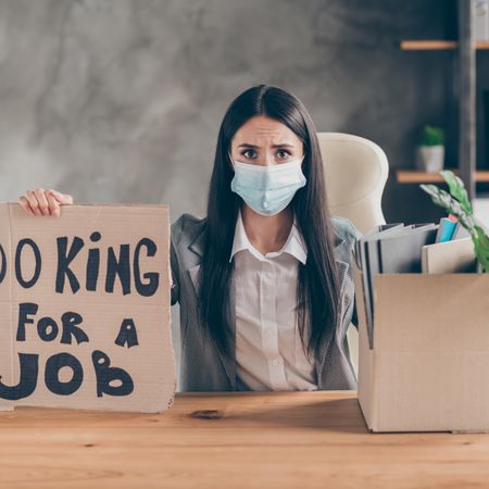 I Need Work Frustrated Stressed Girl Ceo Marketer Banker Sit Table Desk Lose Job Company Covid Economics Crisis Show Cardboard Text Box Wear Medical Mask Blazer Jacket Workplace Min