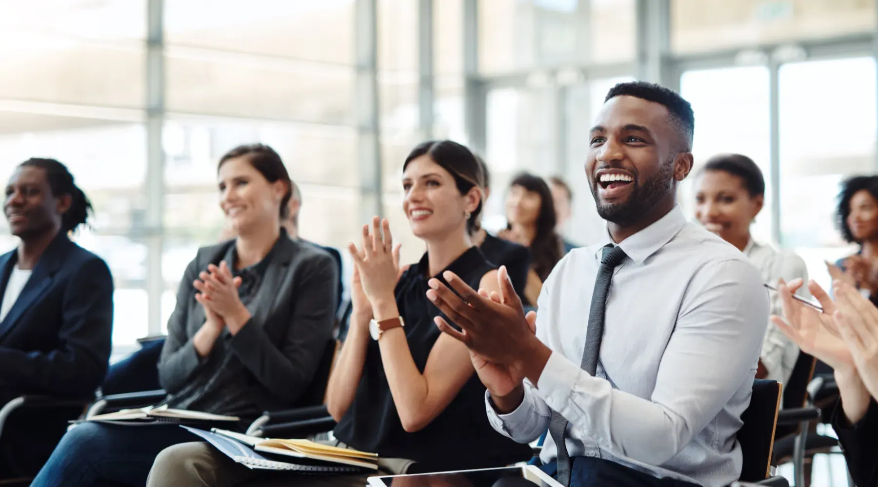 A group of seated people applauding