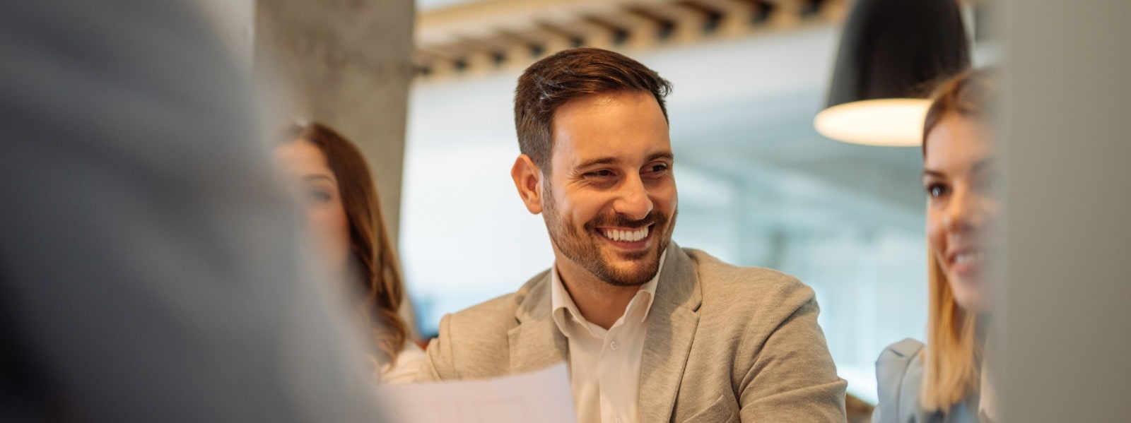 Three finance and accountancy colleagues sit together during a business meeting