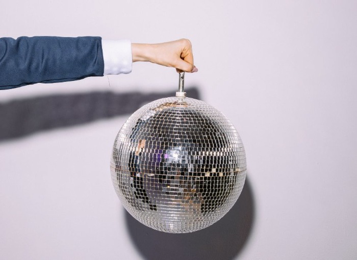 Woman's hand holding out disco ball
