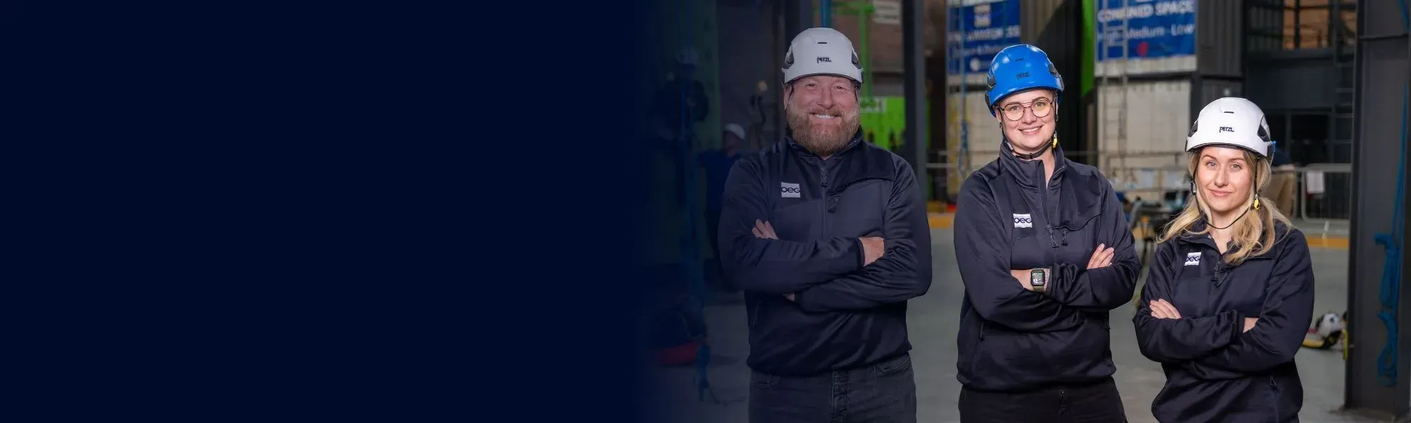 OEG training instructors with arms folded.