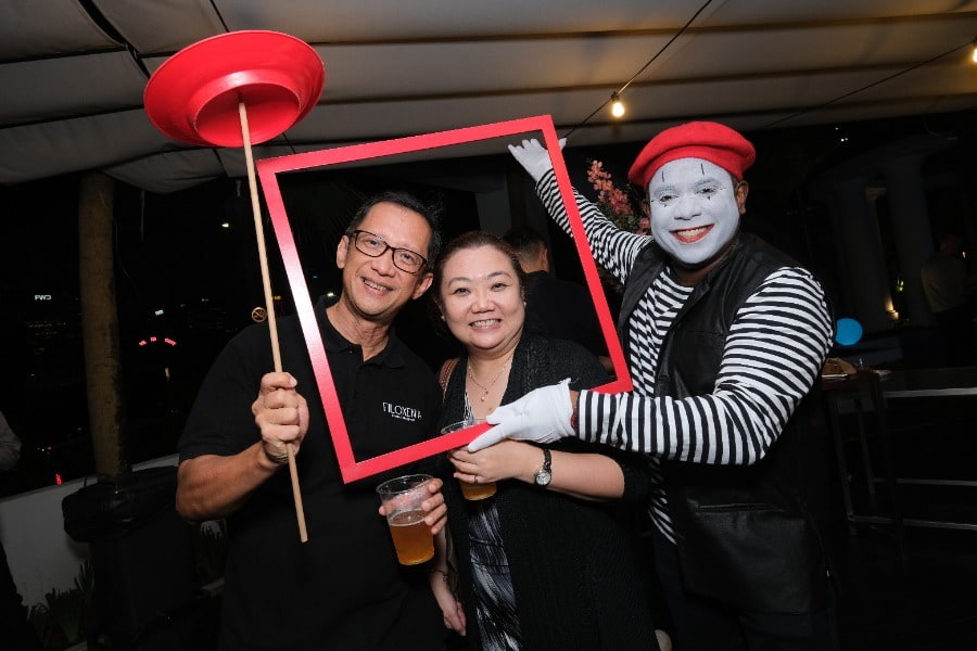 man and woman inside a frame with a mime