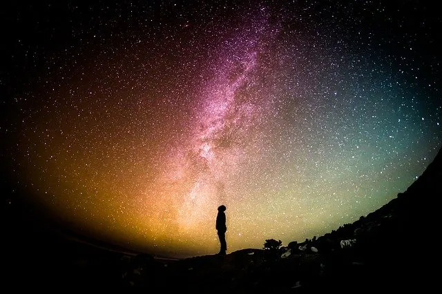 person standing looking up at the moon