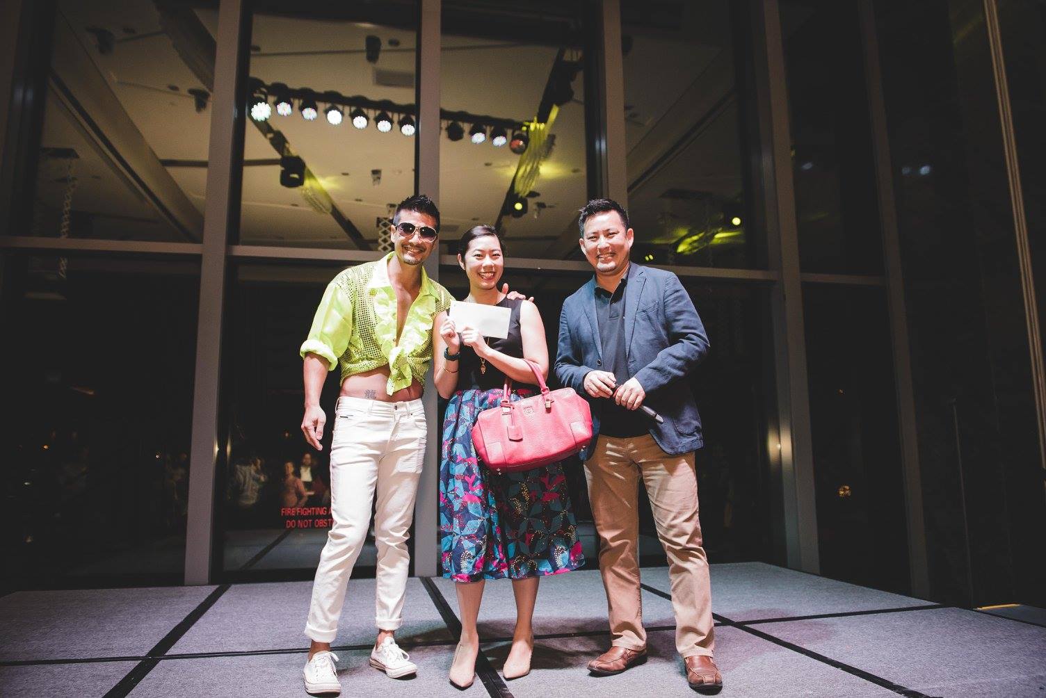 Andrew Chan in Brazil costume on stage with man and woman