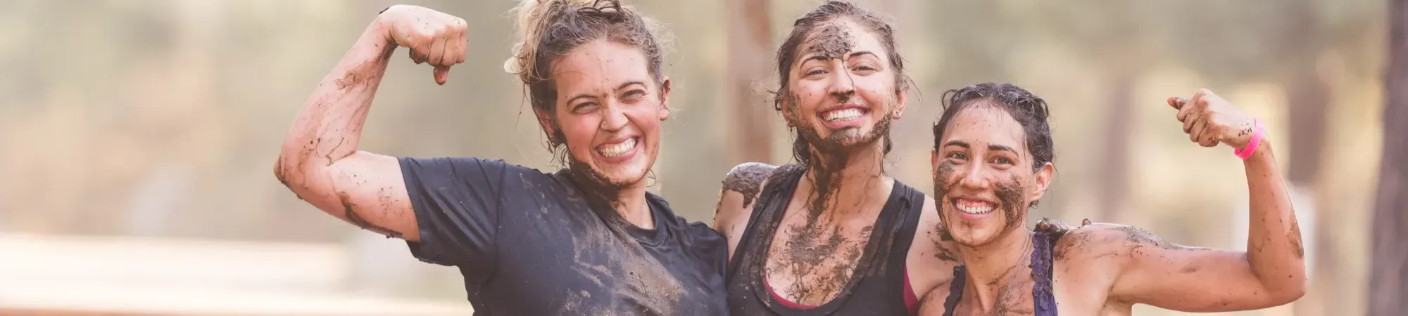 Muddy runners celebrating