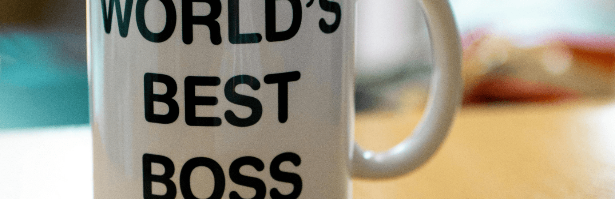 A ceramic mug displaying "World's Best Boss," representing a supportive leader fostering teamwork among colleagues.