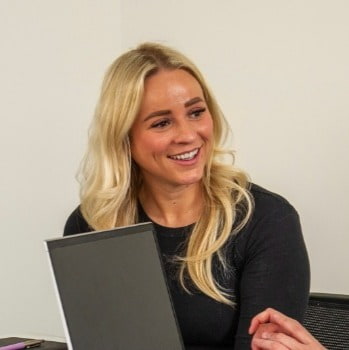 HR Manager smiling with laptop in a meeting