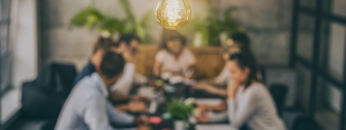 lightbulb moment in corporate office during team meeting 