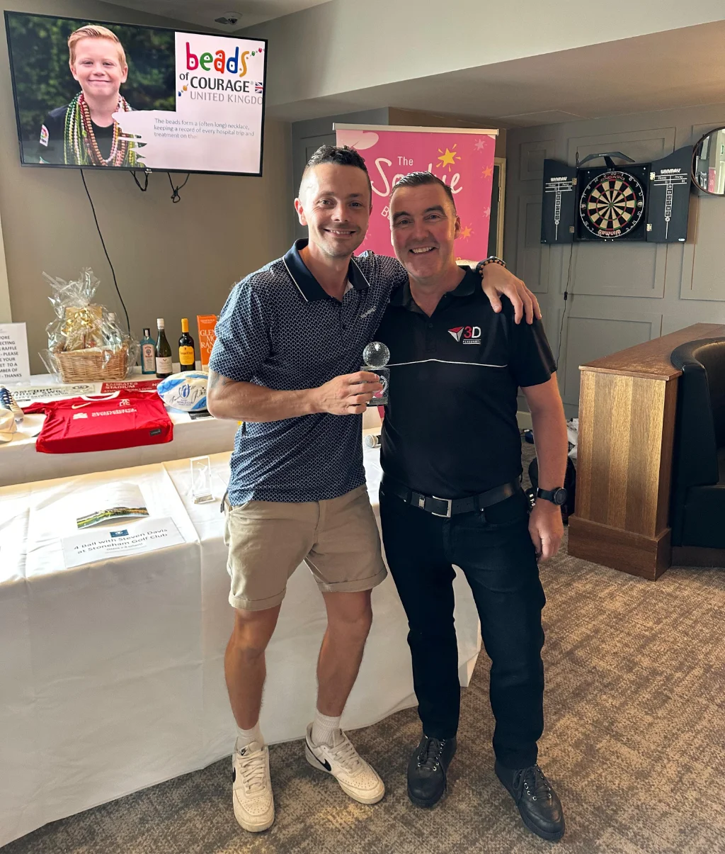Jason from Ridon Joinery collects the Longest Drive trophy from Damian