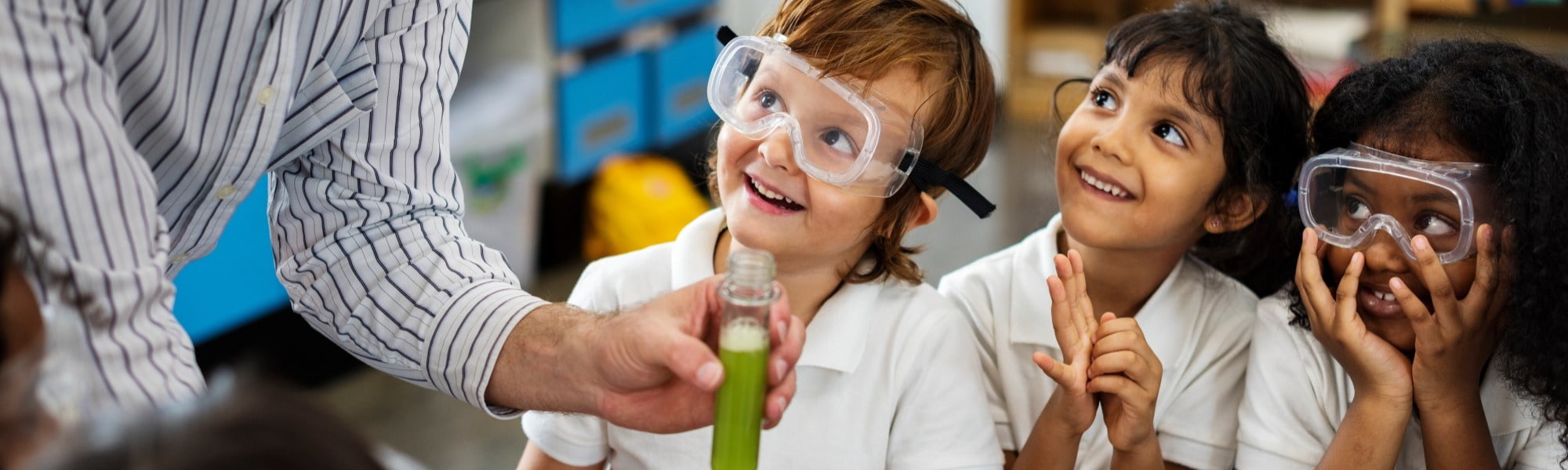 This is a picture of a teacher with their pupils teaching a science lesson