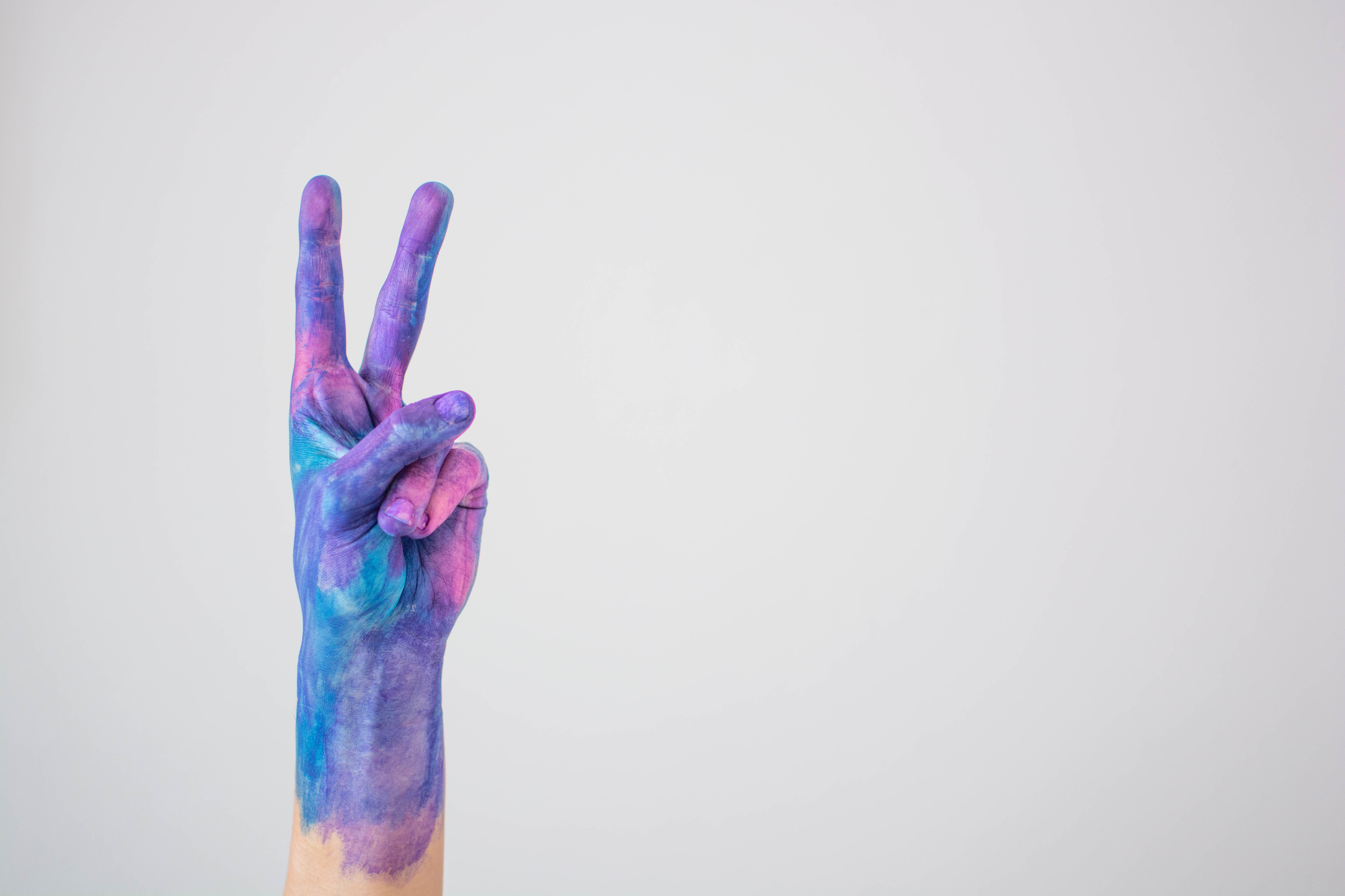 Blue Pink Colored Painted Hand Gesturing Peace Sign