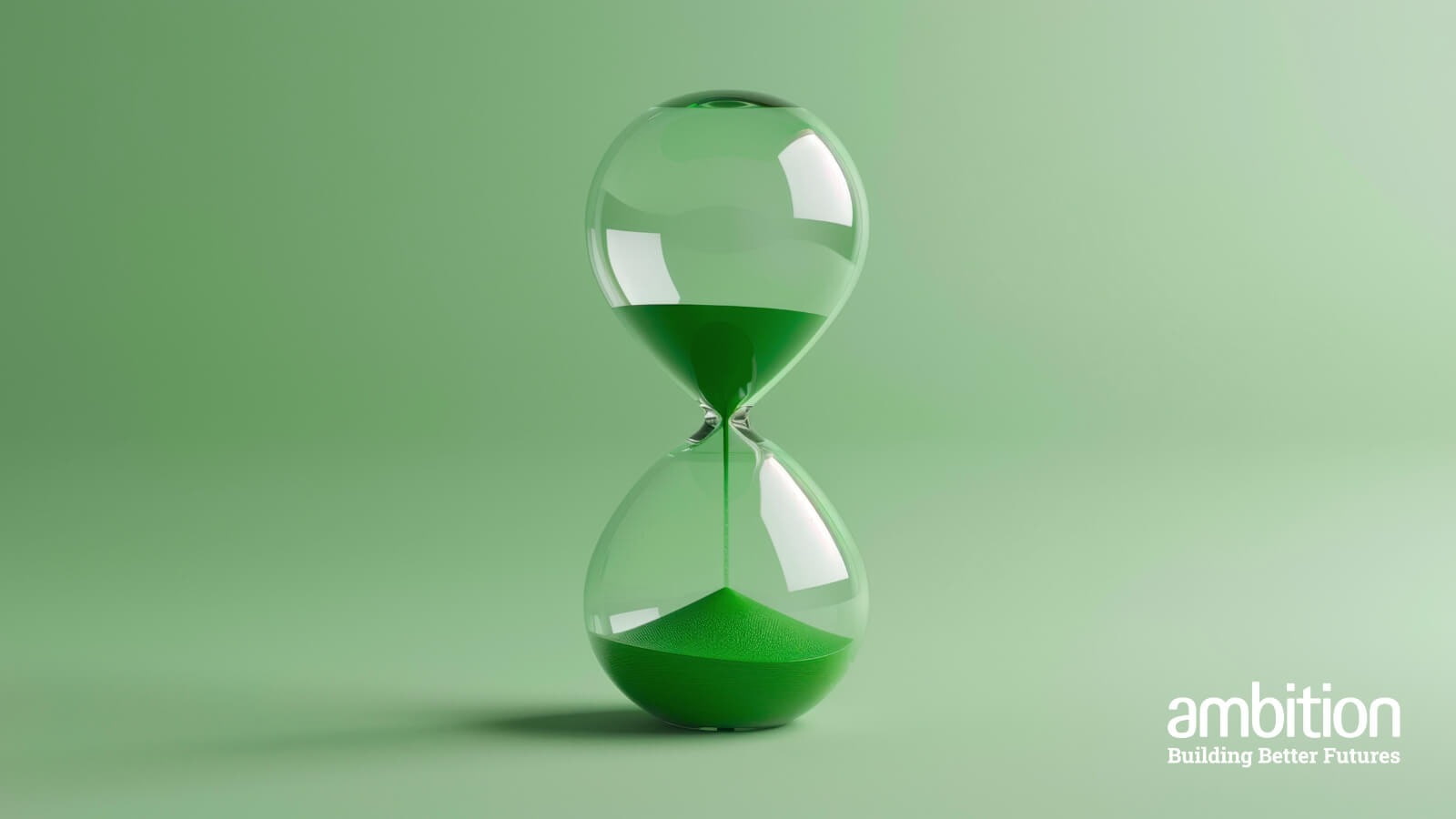 An hourglass with green sand, against a green backdrop. 