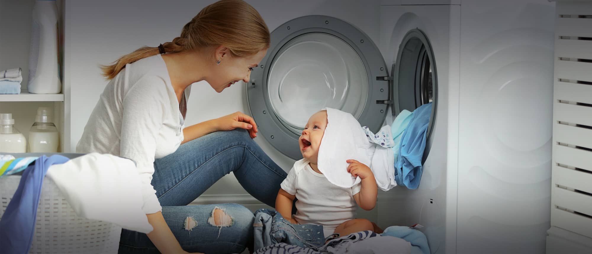 Nanny washing while looking after baby