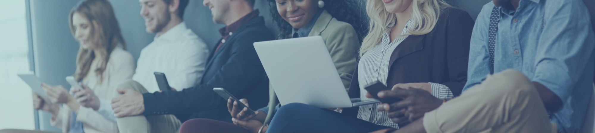 Candour Talent Recruitment Agency - Sectors page. Main Banner Photo. A group of candidates lined up, waiting to be interviewed, surrounded by technology and CVs, reflecting the recruitment process and showcasing the use of modern technology in candidate selection.