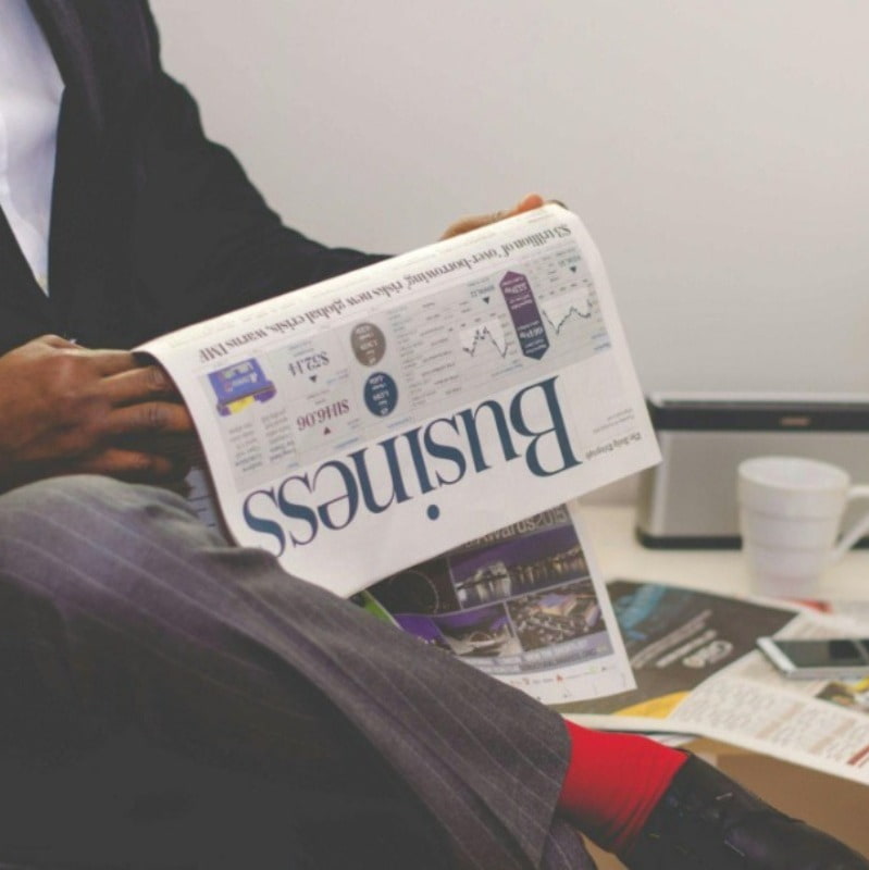 Man holding business newspaper