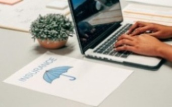 Insurance recruiter on a laptop
