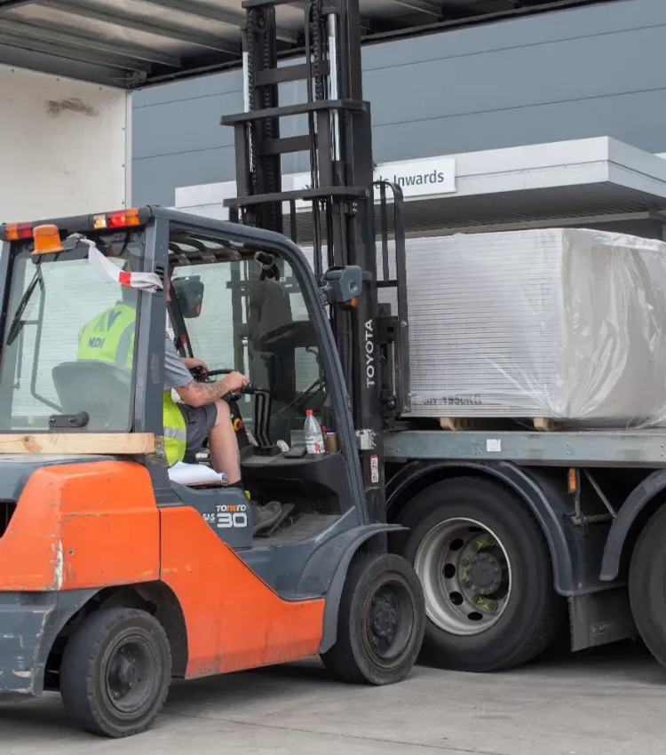 Forklift loading lorry drywall