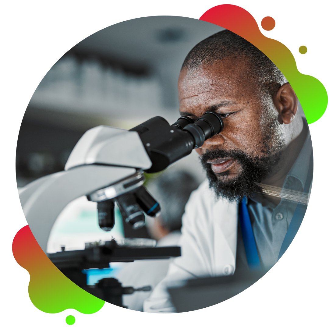 Scientist looking into microscope in a science lab.