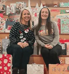 Moneypenny give a day. Employees sat with Christmas gifts